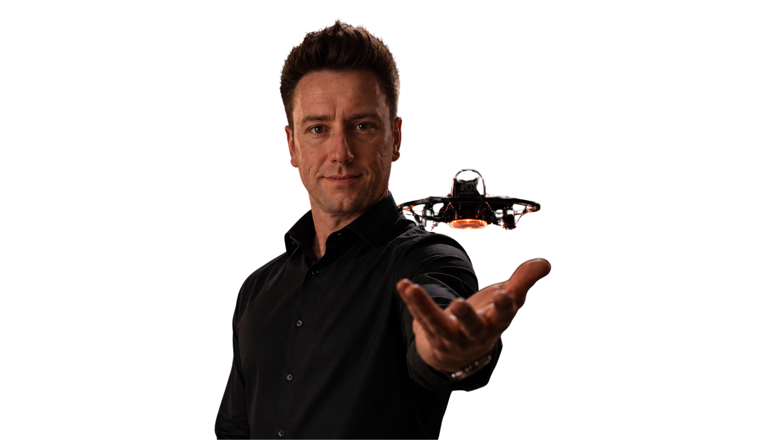 George Chatburn, founder of Inflight, with a drone hovering above his open palm